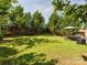 Spacious backyard featuring lush green grass, privacy fence, patio seating and landscaping at 5701 Silver Eagle Dr, Charlotte, NC 28214