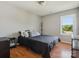 Bedroom featuring a queen bed, wood floor, natural light, and simple decor at 5701 Silver Eagle Dr, Charlotte, NC 28214