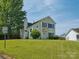 Inviting two-story home with a well-manicured lawn and mature tree providing shade at 5701 Silver Eagle Dr, Charlotte, NC 28214