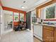 Bright kitchen featuring a modern appliance package, orange accent wall, and lots of natural light at 5701 Silver Eagle Dr, Charlotte, NC 28214