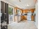 Spacious kitchen featuring tile flooring, a full appliance package and sliding glass door access to the backyard at 5701 Silver Eagle Dr, Charlotte, NC 28214