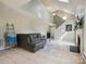 Comfortable living room featuring a fireplace and view of the staircase and a comfortable sectional sofa at 5701 Silver Eagle Dr, Charlotte, NC 28214