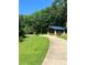 Outdoor park pavilion in a lush green space with mature trees and a curved sidewalk at 5701 Silver Eagle Dr, Charlotte, NC 28214