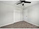 Bedroom showcases a ceiling fan, closet, and neutral carpet for a cozy retreat at 5717 Fairchase Ave, Charlotte, NC 28269