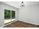 Bright bedroom with hardwood floors and a sliding glass door to a private outdoor space at 5717 Fairchase Ave, Charlotte, NC 28269