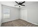Bedroom features a ceiling fan, window, and closet with neutral colored carpet at 5717 Fairchase Ave, Charlotte, NC 28269
