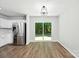 Eat-in kitchen featuring stainless steel appliances, hardwood floors, and sliding glass doors at 5717 Fairchase Ave, Charlotte, NC 28269