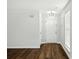 Inviting entryway with hardwood floors, a modern light fixture, and access to other rooms at 5717 Fairchase Ave, Charlotte, NC 28269