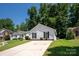 Inviting single-story home with a spacious driveway and a beautifully landscaped front yard at 5717 Fairchase Ave, Charlotte, NC 28269