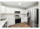 This kitchen features white cabinets, stainless steel appliances, and modern countertops and flooring at 5717 Fairchase Ave, Charlotte, NC 28269