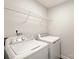 Bright laundry room with storage shelf, washer, and dryer hookups for easy laundry days at 5717 Fairchase Ave, Charlotte, NC 28269