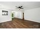 Bright living room with hardwood floors, a ceiling fan, and a view into the kitchen at 5717 Fairchase Ave, Charlotte, NC 28269