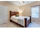 This cozy bedroom features carpet and a large window allowing natural light at 7521 Plumcrest Ln, Harrisburg, NC 28075