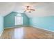 This large bonus room offers hardwood floors and a vaulted ceiling with a window at 7521 Plumcrest Ln, Harrisburg, NC 28075