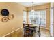 Bright breakfast nook with a round table and natural light from the window at 7521 Plumcrest Ln, Harrisburg, NC 28075