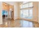This home's entryway features hardwood floors, high ceilings and a large window allowing natural light at 7521 Plumcrest Ln, Harrisburg, NC 28075
