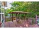 Covered gazebo on wooden deck with swing bench and railing at 7521 Plumcrest Ln, Harrisburg, NC 28075
