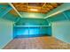 Storage shed interior with blue walls, tile floor, and open shelving at 7521 Plumcrest Ln, Harrisburg, NC 28075