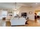 Bright living room with hardwood floors, fireplace, and a view into the main bedroom at 7521 Plumcrest Ln, Harrisburg, NC 28075