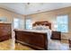 This main bedroom features a vaulted ceiling, wood floors and a large window allowing natural light at 7521 Plumcrest Ln, Harrisburg, NC 28075