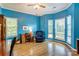This office features hardwood floors, bright blue walls and multiple windows allowing plenty of natural light at 7521 Plumcrest Ln, Harrisburg, NC 28075
