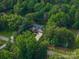 Stunning aerial shot of a home surrounded by lush greenery, showcasing its serene and private setting at 7988 Golf Course N Dr, Denver, NC 28037