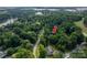 A picturesque aerial shot showcases the property amidst lush trees and a peaceful neighborhood setting at 7988 Golf Course N Dr, Denver, NC 28037