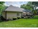 Landscaped backyard featuring a spacious deck, perfect for outdoor gatherings and enjoying serene views at 7988 Golf Course N Dr, Denver, NC 28037