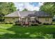 Well-maintained backyard with a spacious deck, perfect for outdoor dining, relaxing, and entertaining guests at 7988 Golf Course N Dr, Denver, NC 28037
