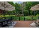 Inviting back yard with lush greenery, well-manicured lawn, and a charming deck for outdoor enjoyment at 7988 Golf Course N Dr, Denver, NC 28037