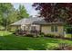 Beautiful backyard view with a well-maintained lawn and a deck area perfect for outdoor entertaining at 7988 Golf Course N Dr, Denver, NC 28037