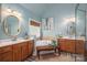 A bright bathroom featuring double sinks, a soaking tub, and a window providing natural light at 7988 Golf Course N Dr, Denver, NC 28037