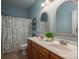 Bathroom highlighting a dual-sink vanity, decorative mirrors, and a tub and shower combo at 7988 Golf Course N Dr, Denver, NC 28037