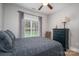 Bedroom showcases neutral walls, a dark grey bedspread, and a large window at 7988 Golf Course N Dr, Denver, NC 28037