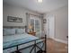 This cozy bedroom features a patterned duvet, plush carpet, and natural light at 7988 Golf Course N Dr, Denver, NC 28037