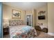 A cozy bedroom offering a decorative bed, warm neutral walls, and access to the ensuite at 7988 Golf Course N Dr, Denver, NC 28037