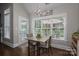 Bright breakfast nook features dark floors, light gray walls, and windows overlooking the backyard at 7988 Golf Course N Dr, Denver, NC 28037