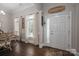 Bright foyer featuring hardwood floors and an entry door, complemented by elegant decor at 7988 Golf Course N Dr, Denver, NC 28037