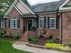 Inviting front entrance with manicured landscaping and a charming brick facade at 7988 Golf Course N Dr, Denver, NC 28037