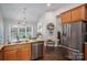 Open kitchen with stainless appliances, granite counters, light gray walls, and a breakfast nook at 7988 Golf Course N Dr, Denver, NC 28037