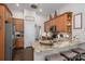 Kitchen featuring stainless steel appliances, granite countertops, wood cabinets, and barstool seating at 7988 Golf Course N Dr, Denver, NC 28037