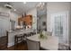 Open concept kitchen features a breakfast bar with seating, a chandelier, and stainless steel appliances at 7988 Golf Course N Dr, Denver, NC 28037