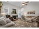 Bright living room featuring a fireplace, hardwood floors, and comfortable seating at 7988 Golf Course N Dr, Denver, NC 28037
