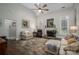 Spacious living room featuring a fireplace, ceiling fan, and ample seating at 7988 Golf Course N Dr, Denver, NC 28037
