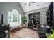 Cozy home office with large window, shelving and desk, offering a comfortable workspace at 7988 Golf Course N Dr, Denver, NC 28037
