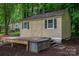 A well maintained shed featuring a deck is nestled in a lush yard at 7988 Golf Course N Dr, Denver, NC 28037