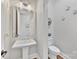 Elegant powder room with a pedestal sink, decorative wall art, and modern lighting at 920 Terramore Dr, Waxhaw, NC 28173