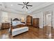 Large bedroom featuring wood floors, a ceiling fan, ornate furniture, and an accent chair at 920 Terramore Dr, Waxhaw, NC 28173