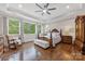 Spacious bedroom with hardwood floors, decorative furniture, and natural light at 920 Terramore Dr, Waxhaw, NC 28173