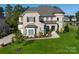 Beautiful stone house with manicured lawn and landscaping, featuring a turret architectural detail at 920 Terramore Dr, Waxhaw, NC 28173